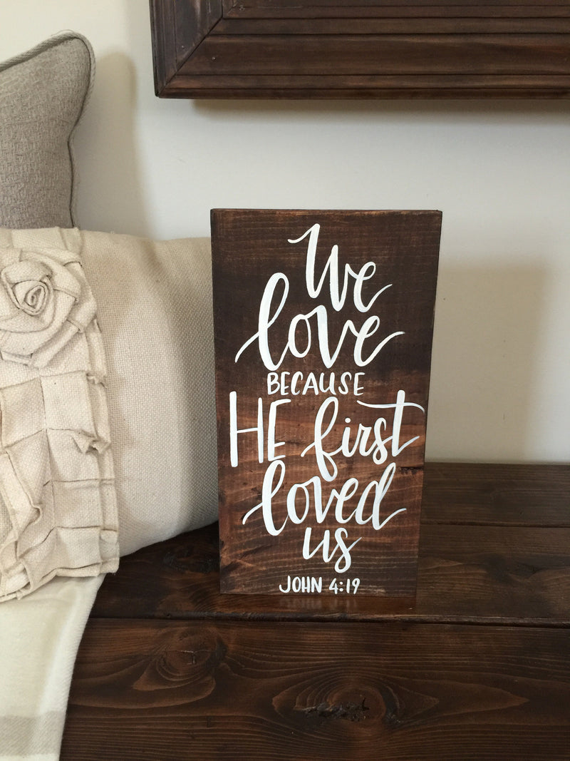 We love because he first loved us wood sign